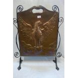 AN ARTS & CRAFTS COPPER FIRE SCREEN with a wrought iron stand, 73cm high