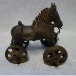 A TIBETAN STYLE METAL PULL-ALONG HORSE, 14cm wide x 14cm high