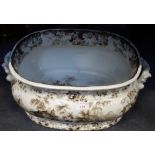 A VICTORIAN BROWN TRANSFER DECORATED FOOT BATH, 49cm wide x 22cm high