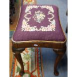 A GEORGE I STYLE WALNUT STOOL, with cabriole legs and woolwork upholstery