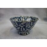 AN ORIENTAL BOWL, with irregular dabbed blue underglaze blue, and some red glaze spots