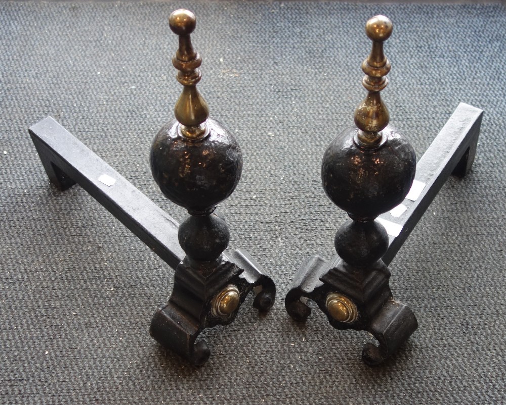 A PAIR OF 17TH CENTURY STYLE IRON FIRE DOGS with brass fittings