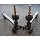 A PAIR OF 17TH CENTURY STYLE IRON FIRE DOGS with brass fittings