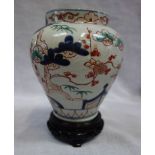 A JAPANESE VASE, IN THE IMARI STYLE, 17 cm high, with a wooden stand