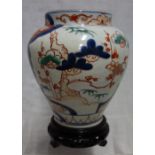 A JAPANESE VASE, IN THE IMARI STYLE, 17 cm high, with a wooden stand