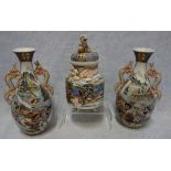 A SATSUMA POTTERY GARNITURE, moulded with dragons and profusely painted with scenes of warriors