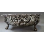 A SILVER EMBOSSED SHALLOW DISH, with lion mask feet, approx 4.35oz