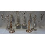 A PAIR OF 19TH CENTURY SILVER PLATED ROCOCO CANDLESTICKS and two similar pairs