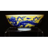 CHINESE YELLOW GROUND "DRAGON" BOWL decorated in underglaze blue with dragons chasing flaming