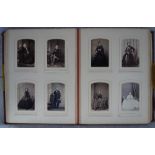 A VICTORIAN EMBOSSED RED LEATHER PHOTOGRAPH ALBUM containing many cabinet portraits and a 19th