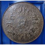 A CAST IRON REPRODUCTION OF A CLASSICAL ANTIQUE SHIELD, decorated with battling figures, 52cm diam