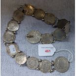 AN UNMARKED WHITE METAL COIN BELT