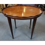 AN EDWARDIAN MAHOGANY OVAL TRAY TOP TABLE, with brass handles, 80cm wide