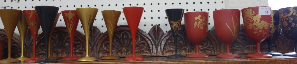 A COLLECTION OF JAPANESE RED, BLACK AND GILT LACQUERED wooden drinking goblets and beakers decorated