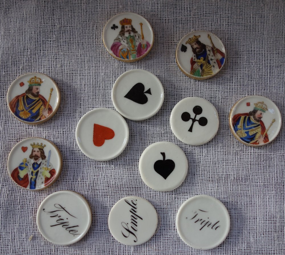 A COLLECTION OF 19TH CENTURY CERAMIC GAMING CHIPS, to include the King of diamonds
