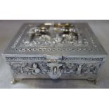 A SILVER EMBOSSED CASKET, with hinged lid and scrolled handle, 12cm wide x 10cm deep, approx 9.10oz
