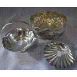 A SILVER EMBOSSED BOWL on a pedestal base, a shell butter dish and a swing handled basket (3)