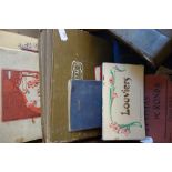 A 1920S SCRAPBOOK, with French photos and postcards, a collection of postcard books, guide books and