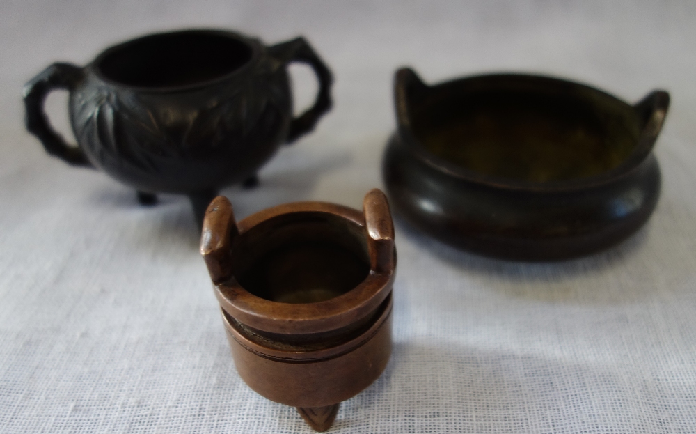 A MINIATURE CHINESE BRONZE TRIPOD CENSER with bamboo shaped handles, stamp to base and two smaller