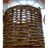 A LARGE WOVEN RATTAN LOG BASKET, 64cm high