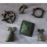 A LURISTAN BRONZE with horses head motif, a bronze boss, an archer's ring and similar items, circa
