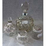 A COLLECTION OF DRESSING TABLE BOTTLES AND JARS, overlaid with silver trim and lids