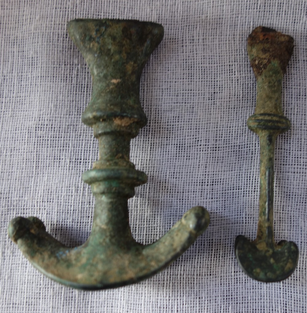 A LURISTAN BRONZE DAGGER HANDLE and a smaller bronze knife, circa 800-600BC