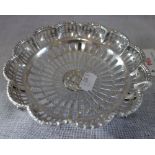 A PIERCED SILVER DISH, with scalloped edge and splayed feet, 13cm diam, approx 3.15oz