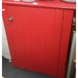 A RED PAINTED PINE KITCHEN CUPBOARD, with boarded door, 74cm wide