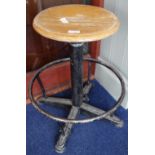 AN INDUSTRIAL STYLE CIRCULAR STOOL, with a wooden seat and iron base