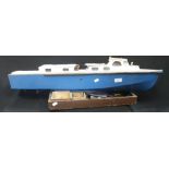 A VINTAGE SCRATCH BUILT MODEL BOAT, with a blue hull, 88cm long