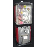 A VINTAGE AMERICAN BUBBLE GUM DISPENSING MACHINE, in red and black with cheap 1$ gifts displayed,