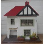 A VINTAGE 1960S DOLL'S HOUSE with period furnishings, 47cm high