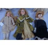 A FRENCH DOLL'S HEAD, stamped, 'S.F.B.J PARIS' with later body, others similar and a collection of