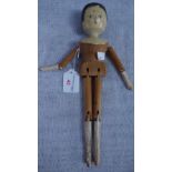 A 19TH CENTURY WOODEN PEG DOLL, with jointed limbs and painted face, (arm off) 30cm high