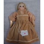 A 19TH CENTURY BISQUE HEADED DOLL, with glass eyes and composite body with limbs and original