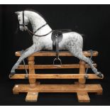 AN EARLY 20TH CENTURY 'SAFETY' ROCKING HORSE, with restored dapple grey paint-work, black leather