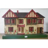 TRI-ANG; A VINTAGE 1930S DOLL'S HOUSE in the Tudor Suburban style, with opening metal framed windows