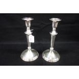 A PAIR OF SILVER CANDLESTICKS, 25cm high (filled)