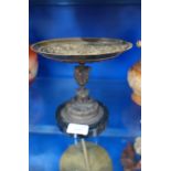 A 19TH CENTURY BRONZE TAZZA decorated with figures in relief, on a black marble base, 17.5cm dia.