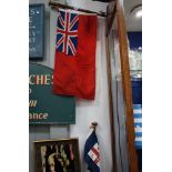 A RED ENSIGN ON A FLAG POLE and a smaller RNLI flag on a pole