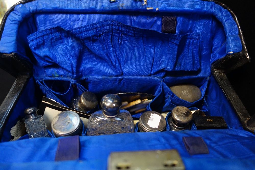 A GLADSTONE BAG containing silver lidded jars and sundries