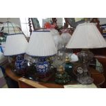 A PAIR OF BLUE AND WHITE TABLE LAMPS, similar table lamps and two oil lamps