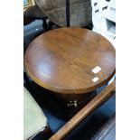 AN OAK 'BARREL' SHAPED TABLE and two iron standard lamps (3)