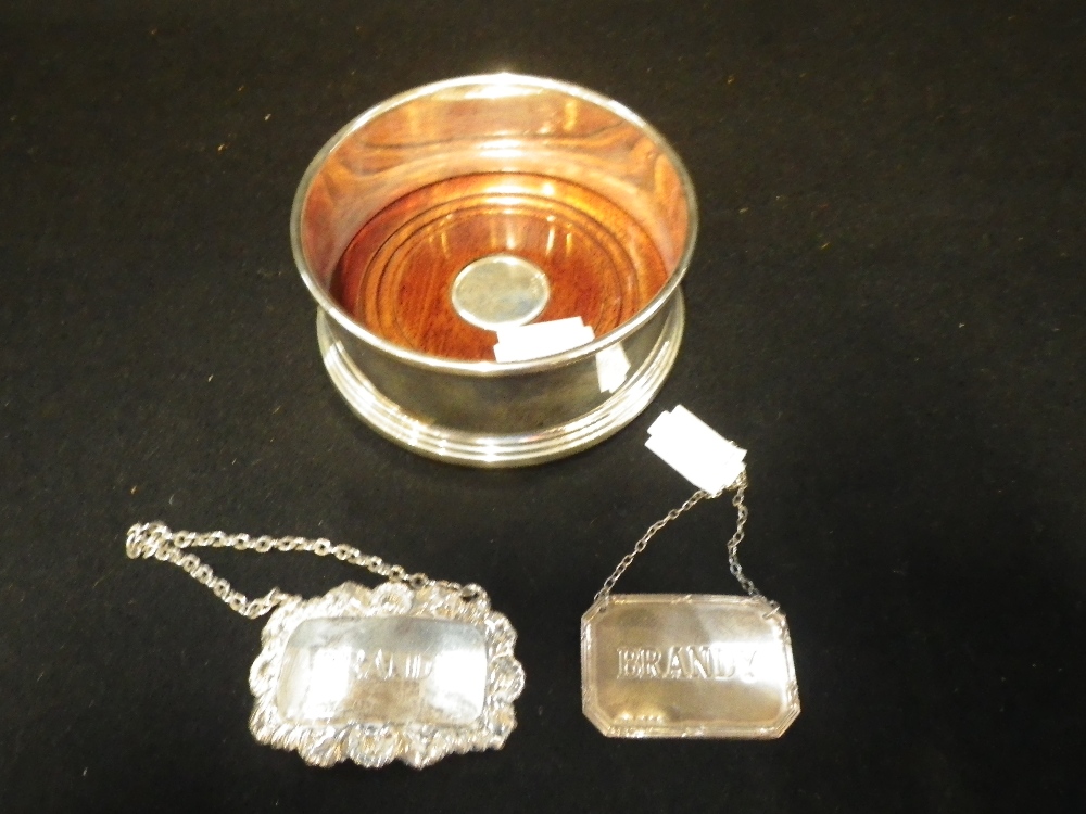 A SILVER AND WOODEN WINE COASTER and two labels (3)