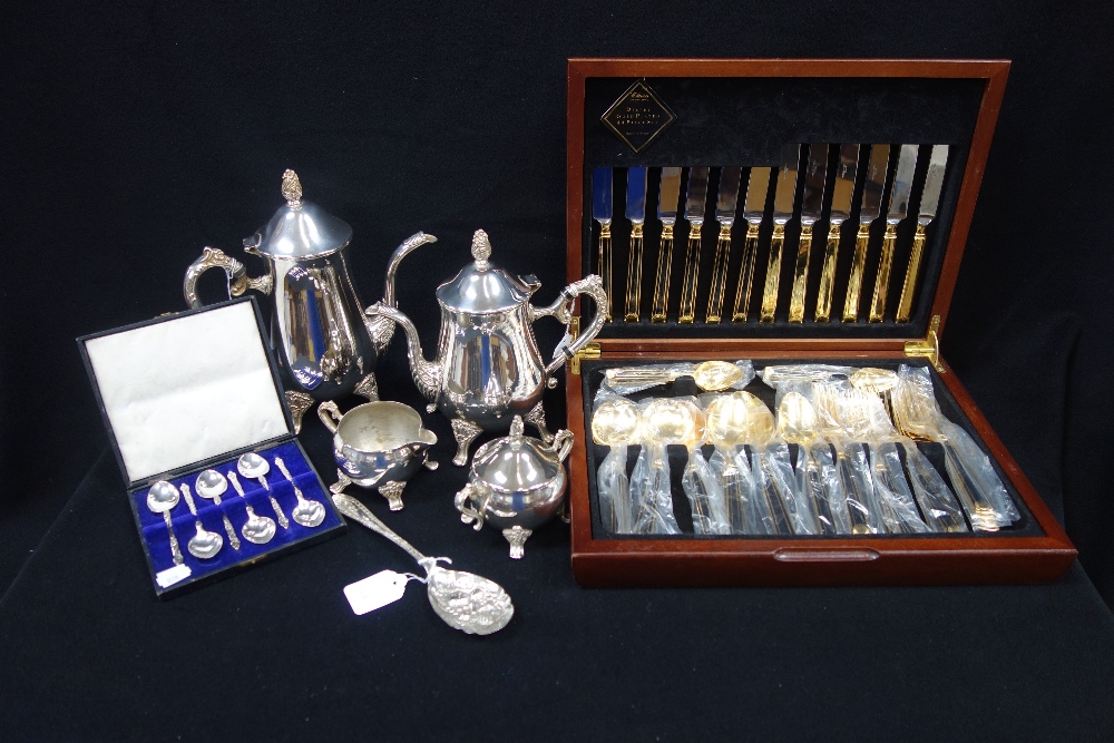 A CANTEEN OF GOLD PLATED CUTLERY, a silver plated coffee service and plated spoons