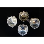 HUNT & ROSKILL LATE STORR AND MORTIMER: A collection of four silver pierced heart shaped dishes,