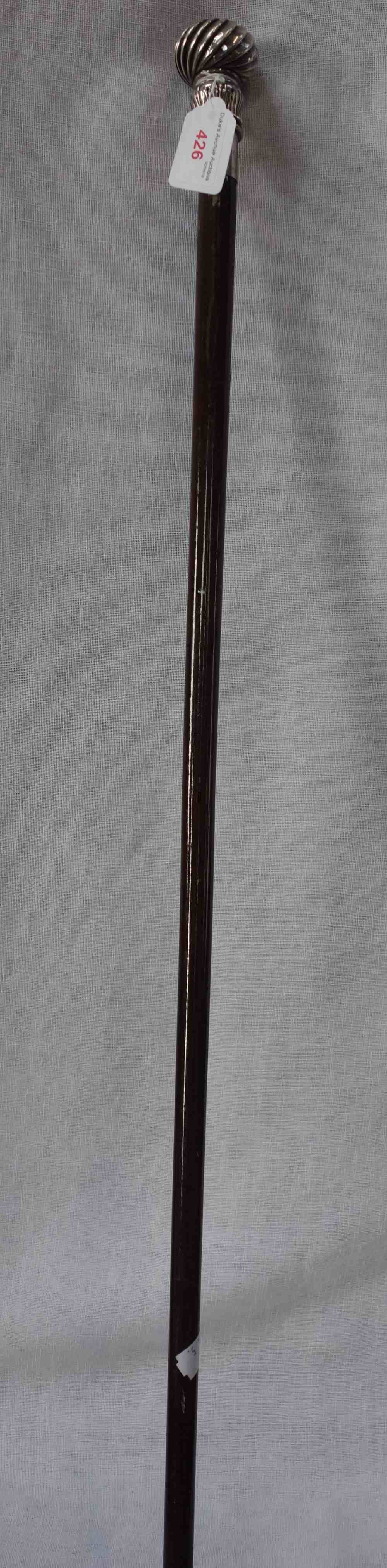 A WALKING STICK with white metal 'reverse' tulip and Wrythen knob