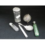 AN EASTERN WHITE METAL PEPPERETTE, decorated with embossed scrolling leaves, a silver caddy spoon,