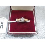 A DIAMOND SOLITAIRE RING, illusion set on an unmarked yellow metal shank, ring size O